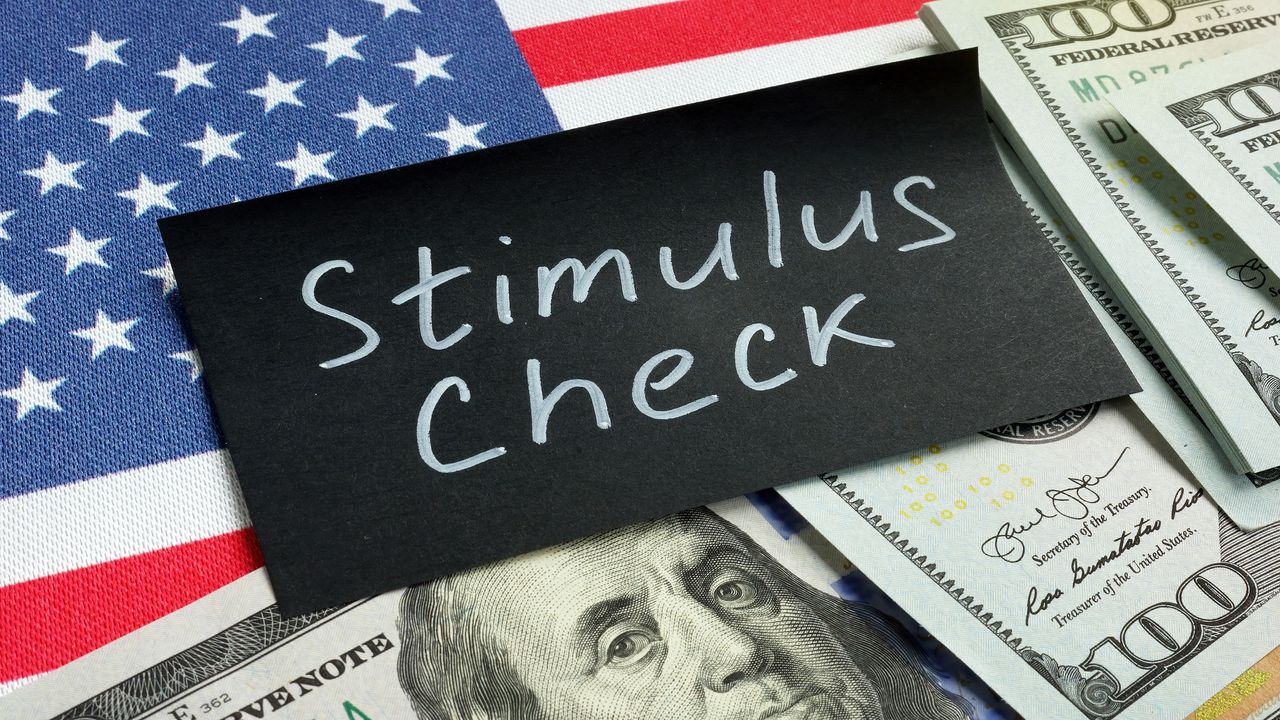 picture of flag, money, and sign saying &amp;quot;stimulus check&amp;quot;