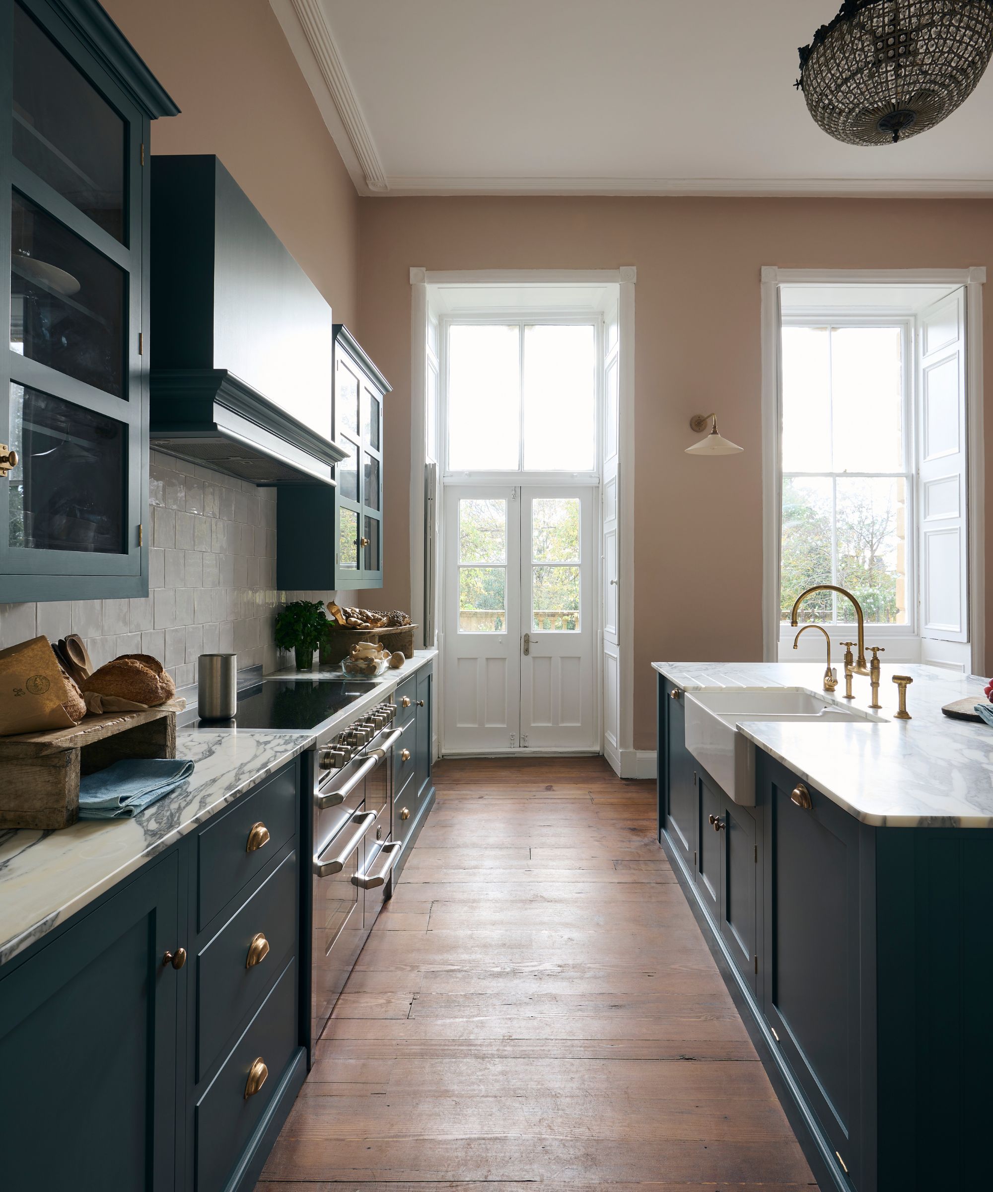 shaker kitchen with plaster pink walls, wood floors and dark blue cabinets