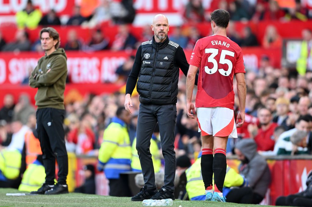 MANCHESTER, ENGLAND - OCTOBER 19: Jonny Evans of Manchester United interacts with his Manager, Erik ten Hag, upon being substituted during the Premier League match between Manchester United FC and Brentford FC at Old Trafford on October 19, 2024 in Manchester, England. (Photo by Michael Regan/Getty Images)