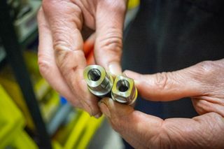 A pair of bottom bracket axles being held together