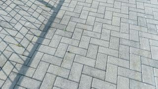 Grey Herringbone block paving brick patternHErring