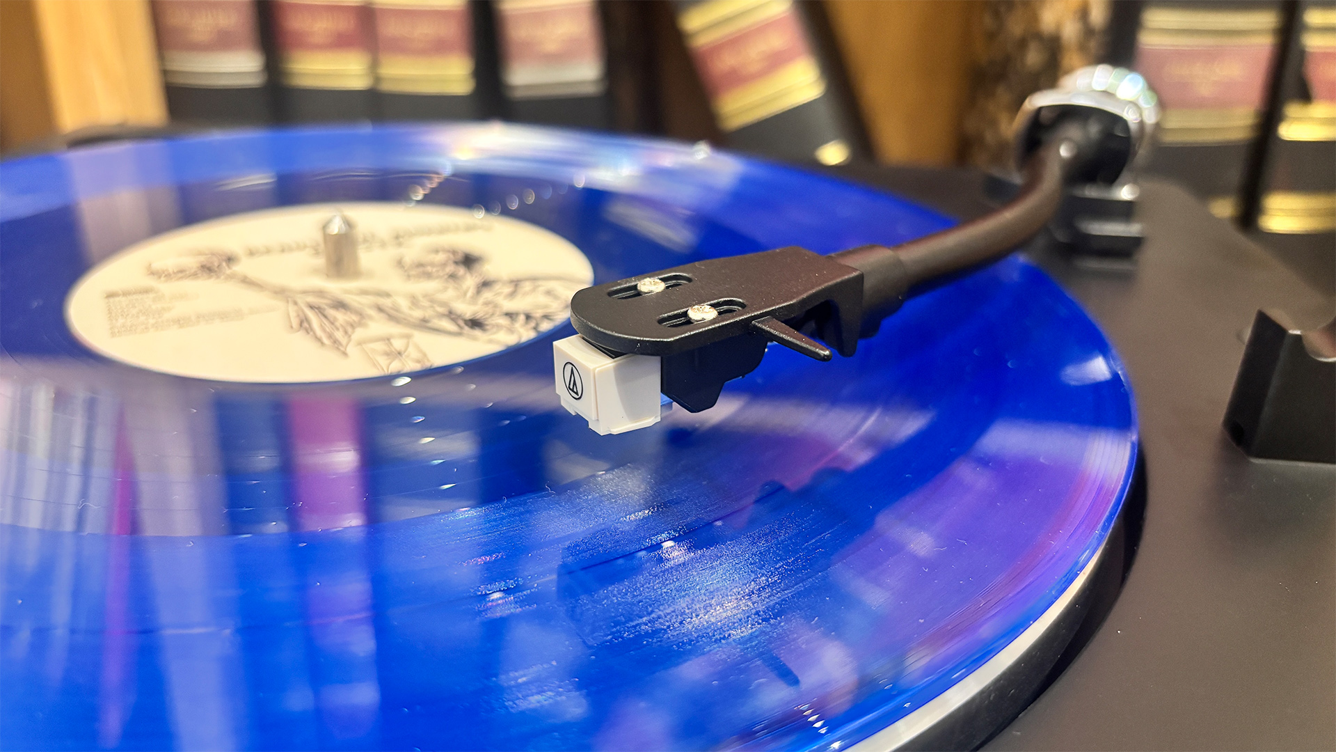 Sharp RP-TT100 Bluetooth turntable playing blue vinyl record
