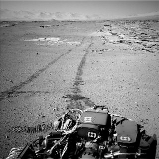 NASA's Curiosity Mars rover used the Navigation Camera (Navcam) on its mast for this look back after finishing a drive of 328 feet (100 meters) on the 548th Martian day, or sol, of the rover's work on Mars (Feb. 19, 2014).