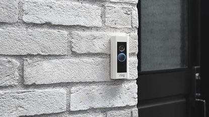 Ring doorbell on white brick