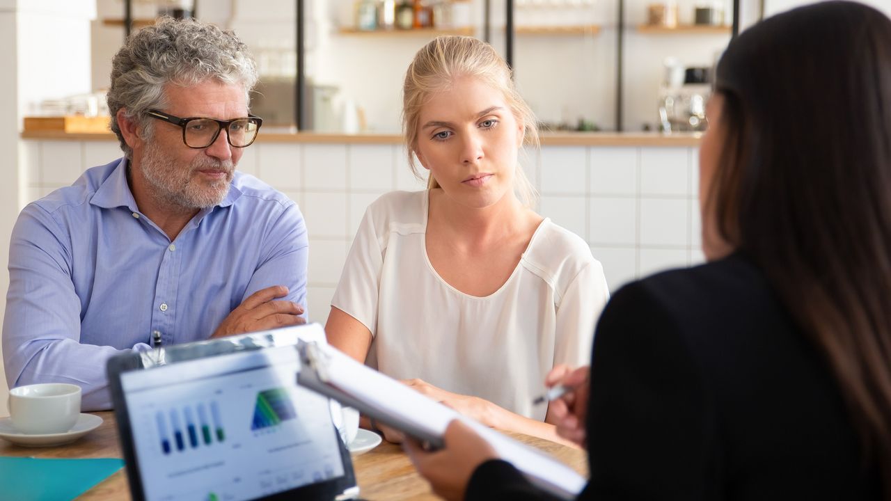 An older couple discuss annuities with their financial adviser.