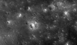 The crater gouged out when NASA's LADEE probe crashed intentionally into the moon on April 18, 2014 is visible as a small white smudge to the upper right of the large central crater in this image captured by the space agency's Lunar Reconnaissance Orbiter.