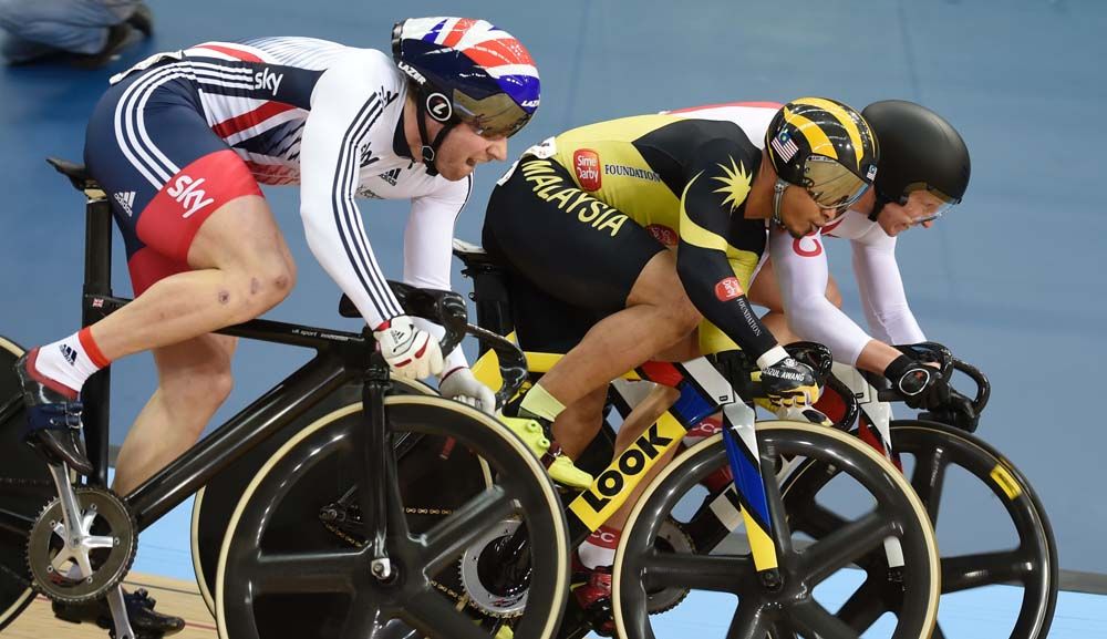 Jason Kenny and Aziz Awang go up against each other in the keirin