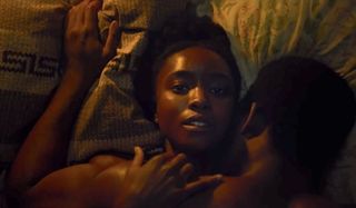 Kiki Layne and Stephen Layne in bed together in If Beale Street Could Talk