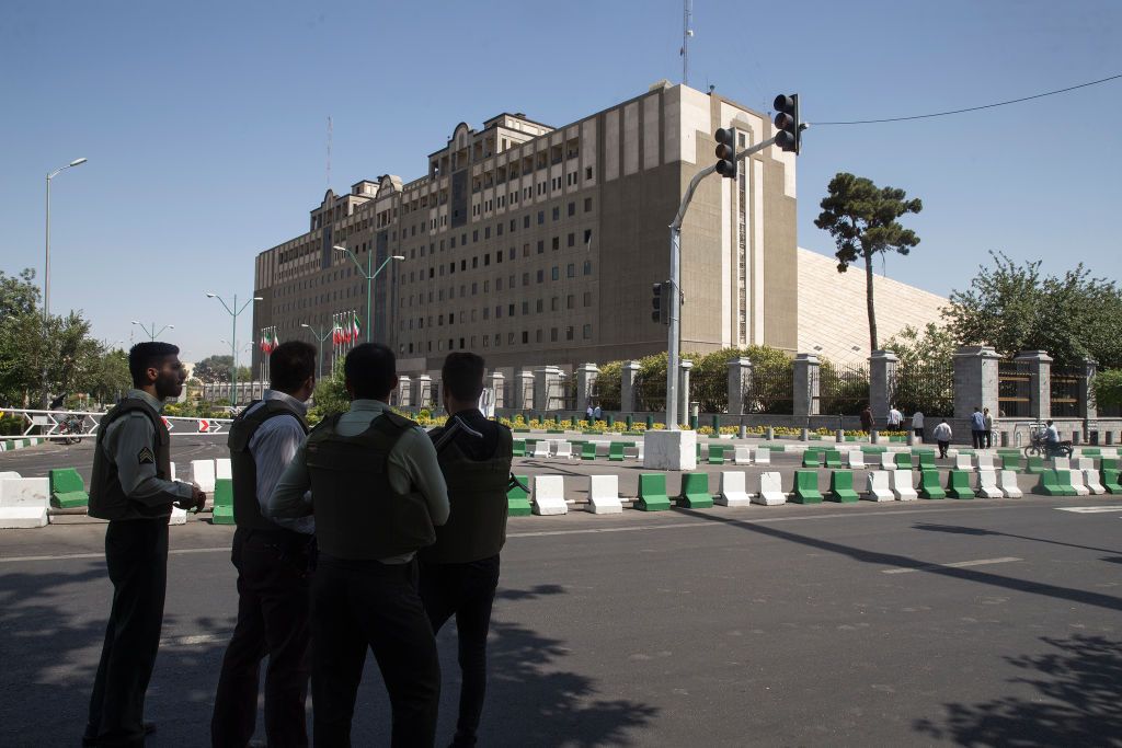 Police officers outside of Iran&amp;#039;s parliament building.