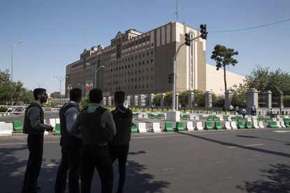 Police officers outside of Iran's parliament building.