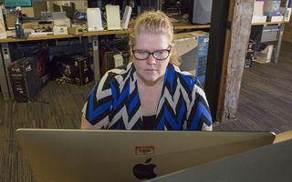 Best antivirus software for mac-book: A woman in a blue and white shirt works on a Mac