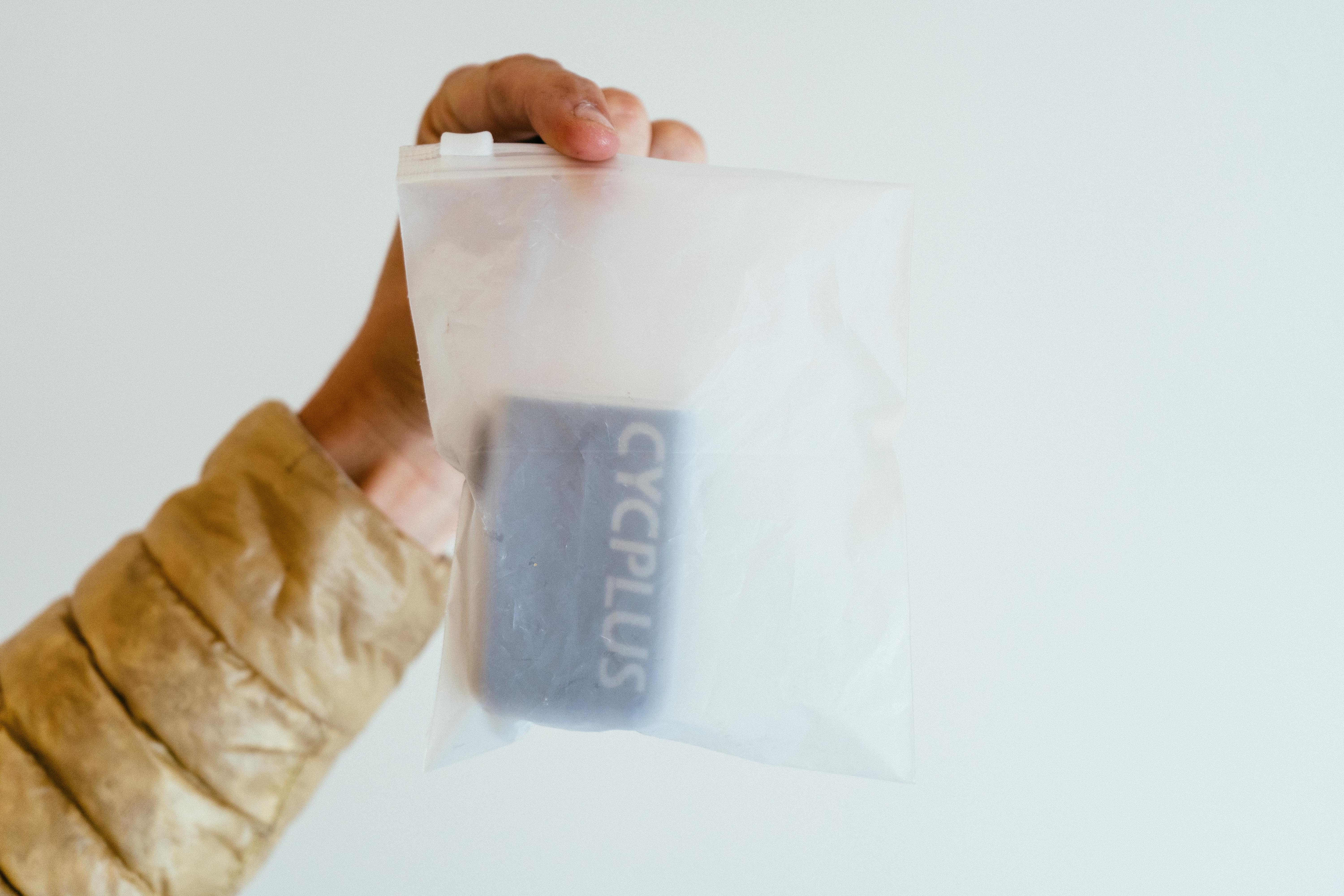 A small black compressor in a translucent ziplock bag