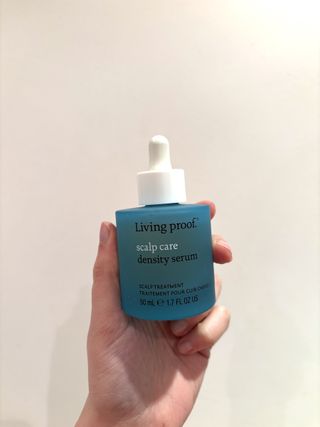 Mica Ricketts holding Living Proof Scalp Care Density Serum