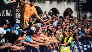 US trailer Courtney Dauwalter celebrates as she crosses the finish line to win the 20th edition of The Ultra Trail du Mont Blanc