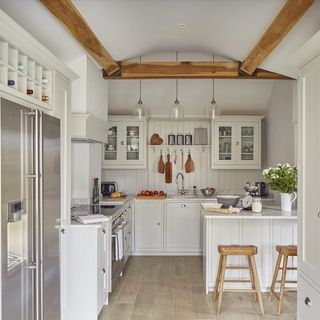 white kitchen with cabinets and fridge