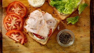 Turkey sandwich in preparation on a chopping board