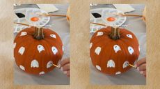 Painting an orange pumpkin with white ghosts