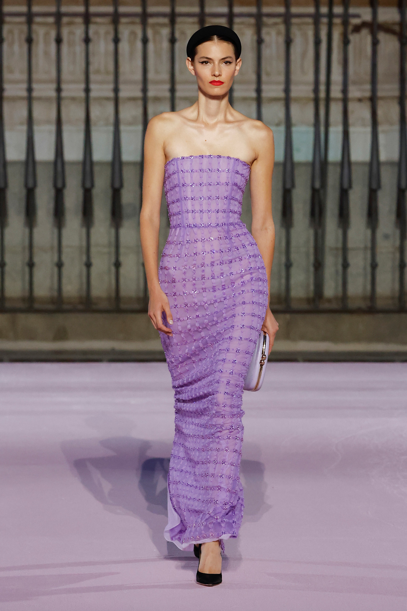 A model at the S/S 26 Carolina Herrera runway show wearing a lilac colored strapless gown.