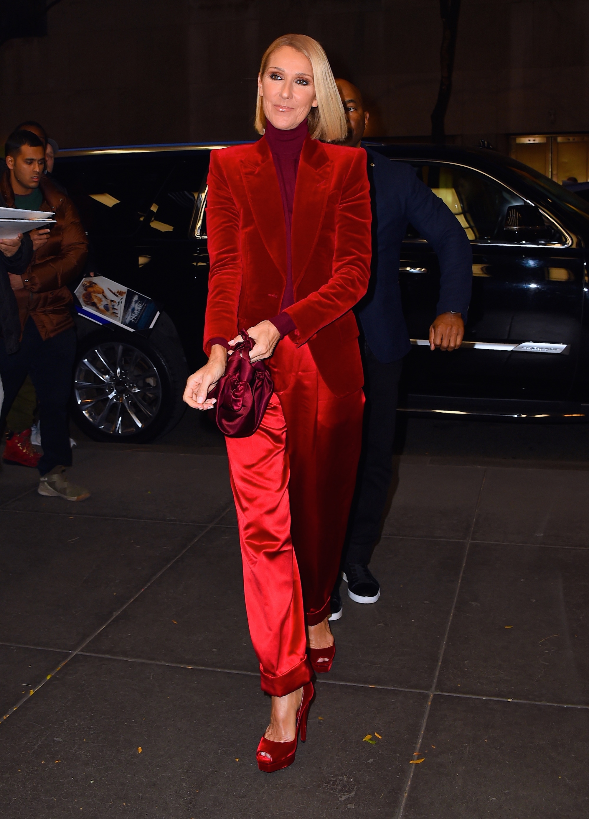 Celine Dion wearing red suit