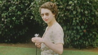 The Queen Unseen - A young Queen wearing sunglasses and holding a Cine camera on Christmas Day, 1953.