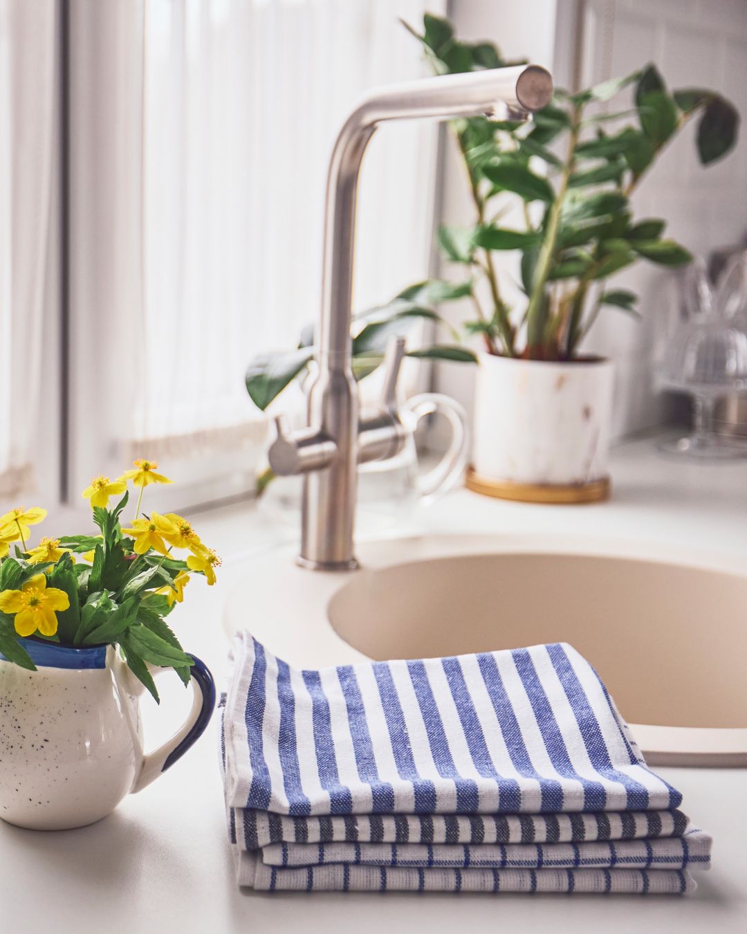 blue and white striped tea towels near kitchen sink