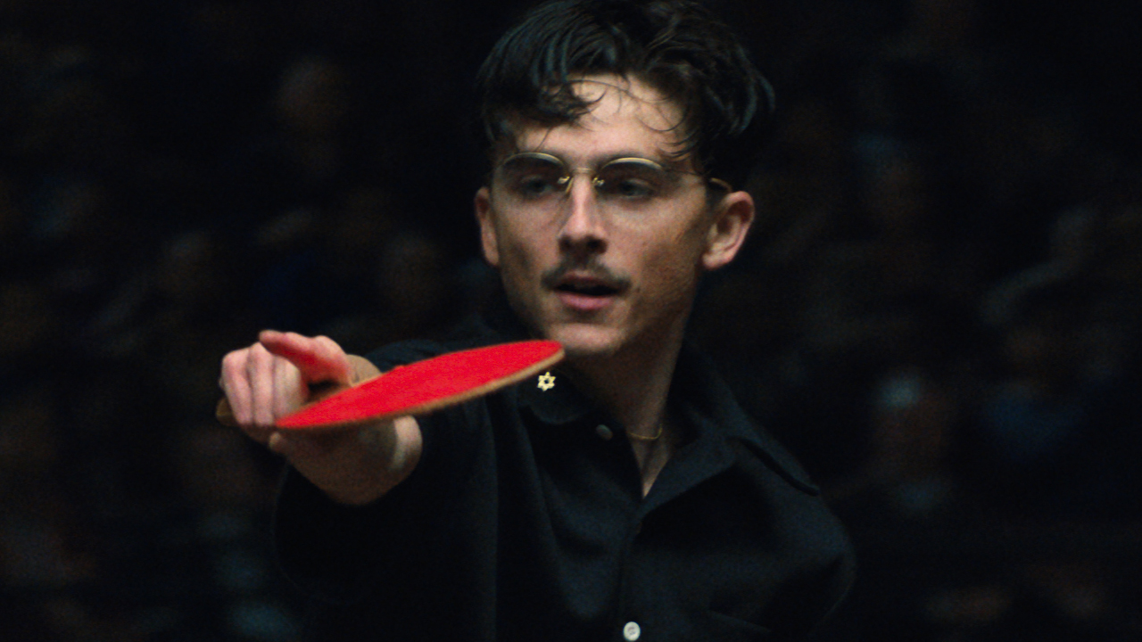 Timoth&eacute;e Chalamet as Marty Mauser holding a table tennis paddle in Marty Supreme