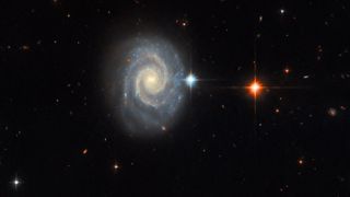 The spiral galaxy MCG-01-24-014 is located 275 million light-years from Earth. Seen face-on, the galaxy has two prominent, well-defined spiral arms and an energetic glowing core known as an active galactic nucleus. 