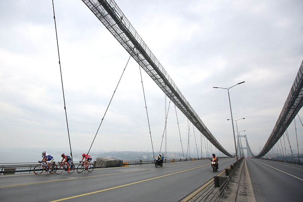 The three rider breakaway on the bridge