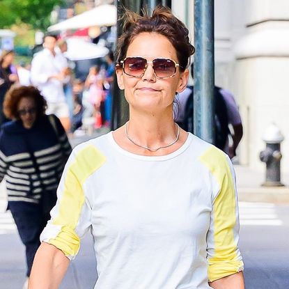 Katie Holmes pulled off the silk slip skirt trend with boat loafer shoes and a butter yellow top