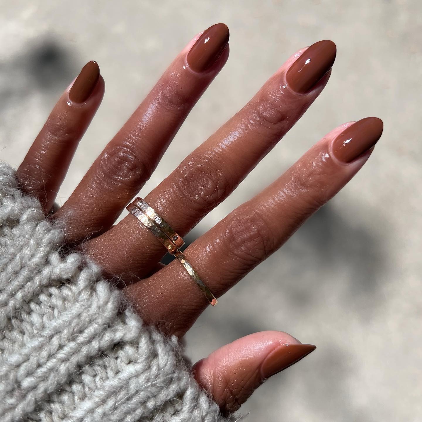 A glossy chestnut brown manicure