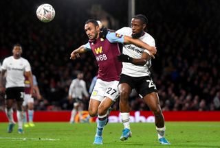 Aston Villa’s Ahmed Elmohamady, left, and Fulham’s Josh Onomah battle for the ball
