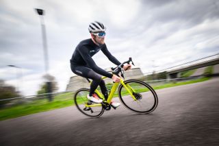 Ed Clancy riding a BMC e-bike in motion blurred image