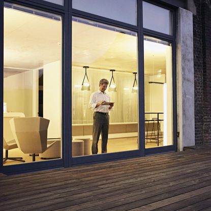 man with glass sliding hanging light