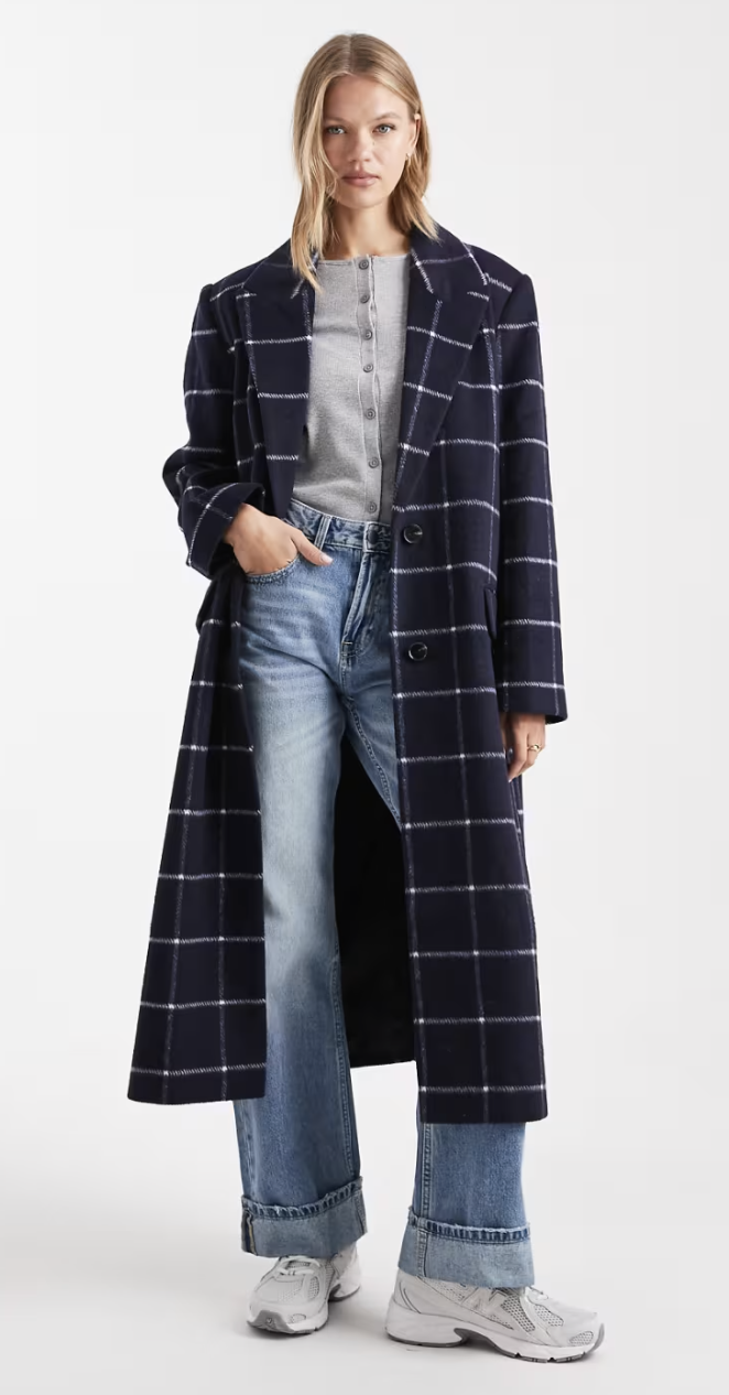 A model wearing a long blue plaid coat
