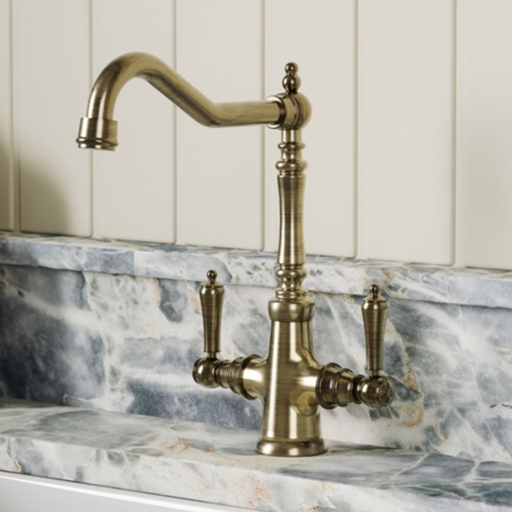 A vintage style brass tap on a marble counter