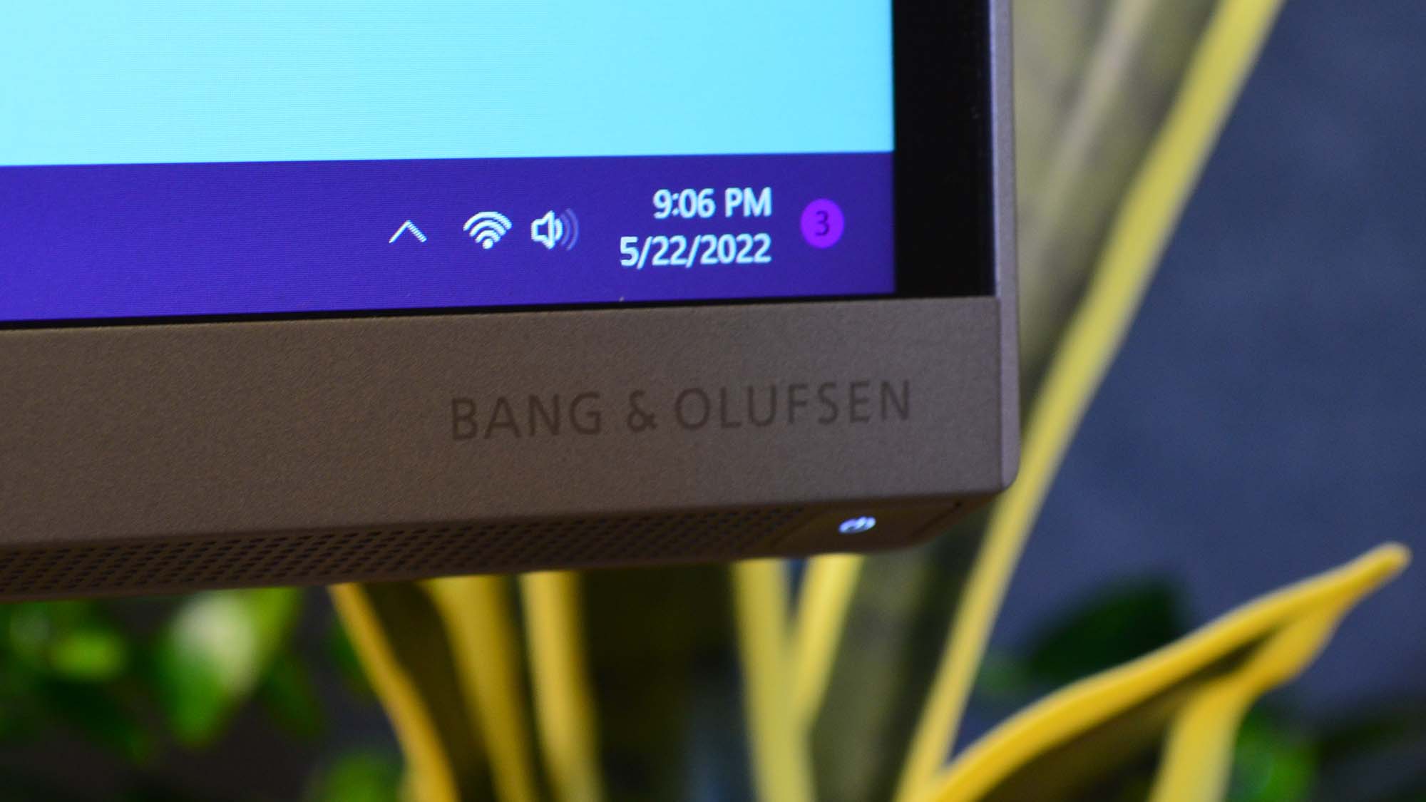 An HP Envy 34 on a desk in front of a plant