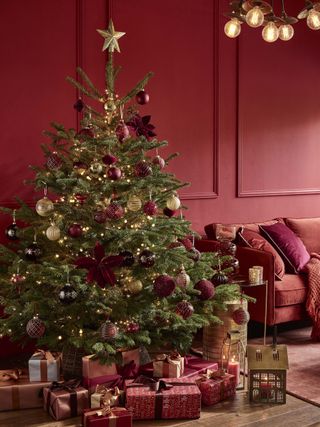 red and gold Christmas tree with red living room walls, red and gold decorations, orange sofa