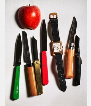 Jaeger-LeCoultre watch beside a row of knives and an apple