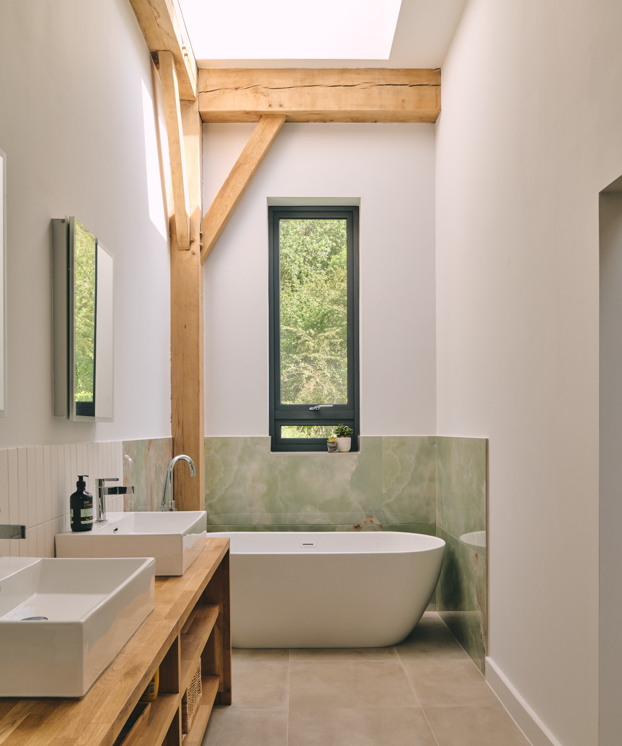 Bathroom with freestanding bath, oak beams and his and hers sinks