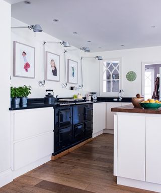 Bright, well lit white U-shaped kitchen ideas with a black aga.