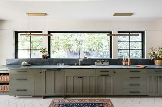 kitchen with green cabinetry and windows