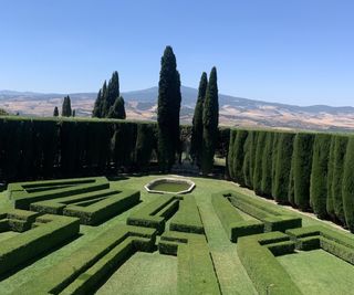 Villa La Foce, with box parterre heding and cypress trees in the Tuscan countryside