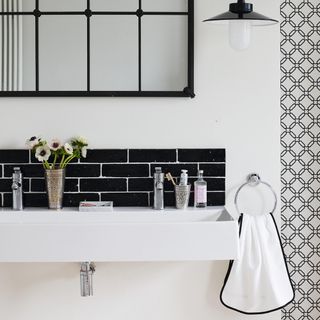 White bathroom with black tiled splashback