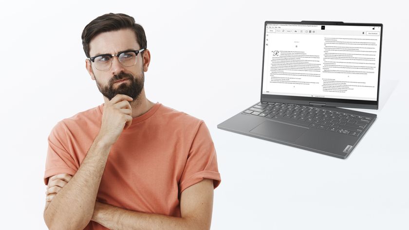 A man looking thoughtfully at a Lenovo ThinkBook Plus Twist laptop.