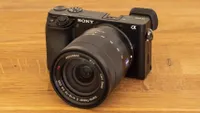 The Sony A6100 camera sat on a table with the 16-70mm lens.