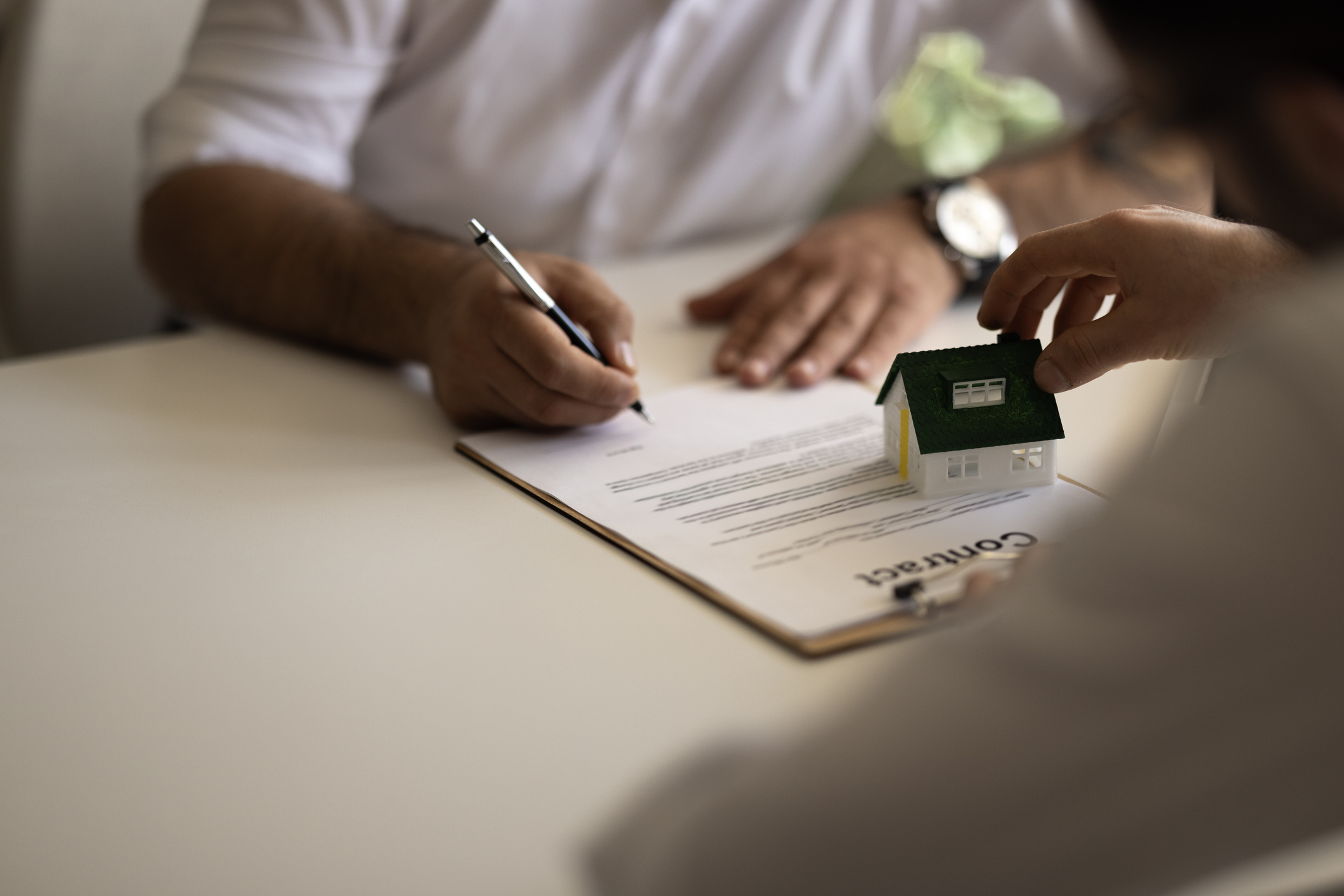 Real estate agent discuss about the terms of the home purchase agreement and asked the customer to sign the documents to make the contract legally, Home sales, lease, mortgage and home insurance. - stock photo