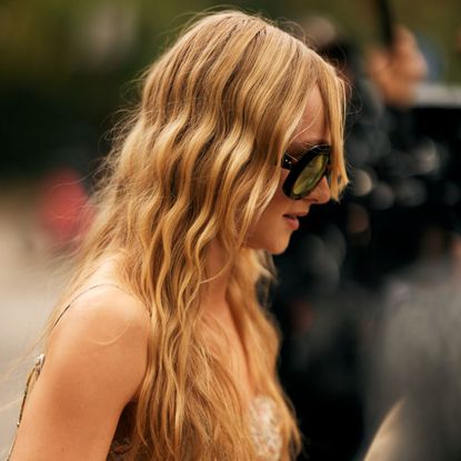 street style shot of blonde woman with wavy hair