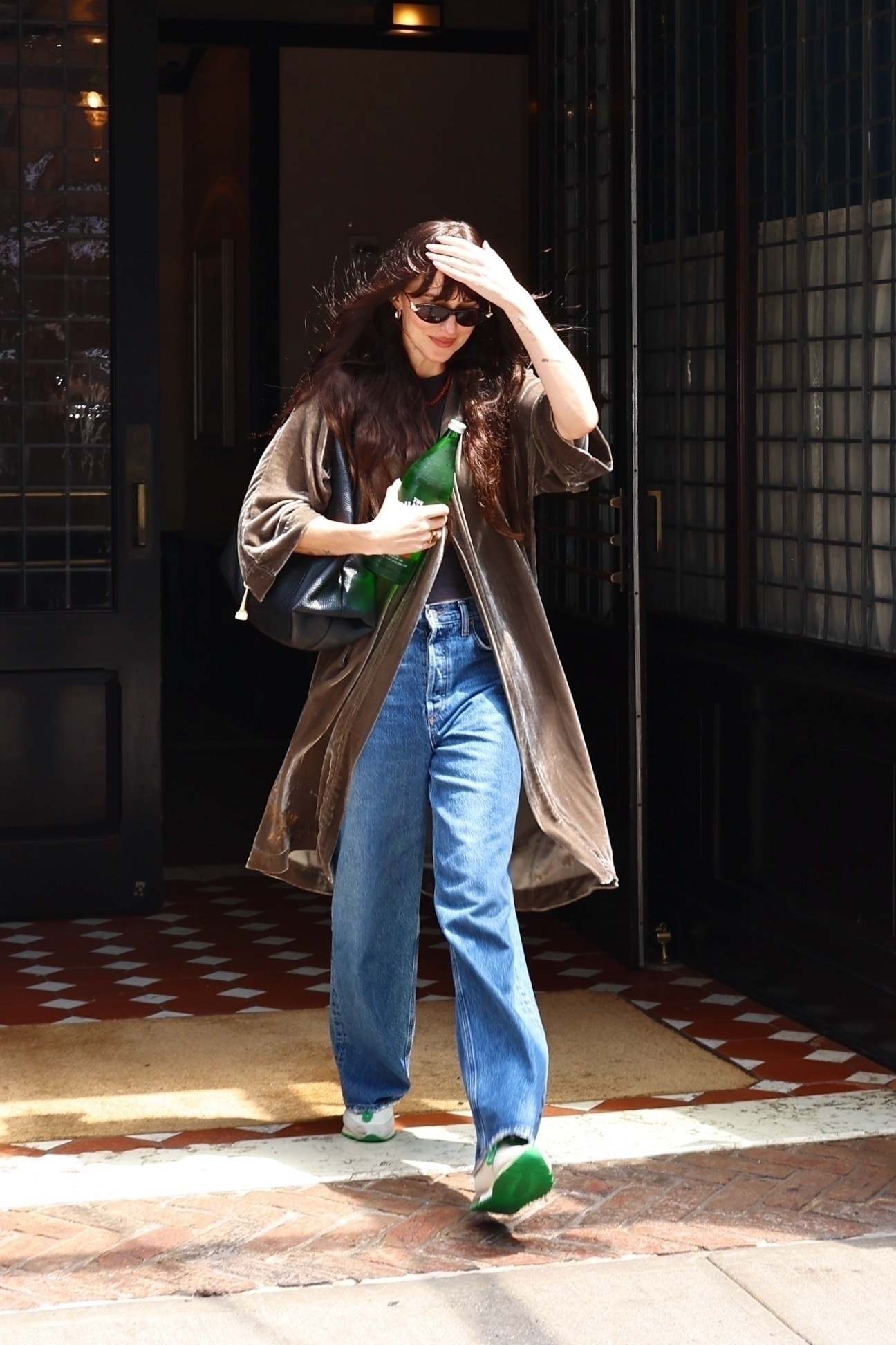 An image of Dakota Johnson wearing retro trainers.