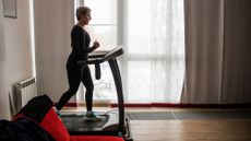Woman using a treadmill at home