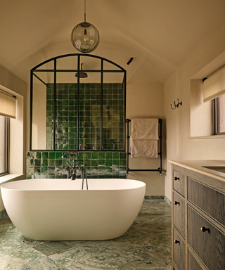 modern bathroom with bath and green tiles